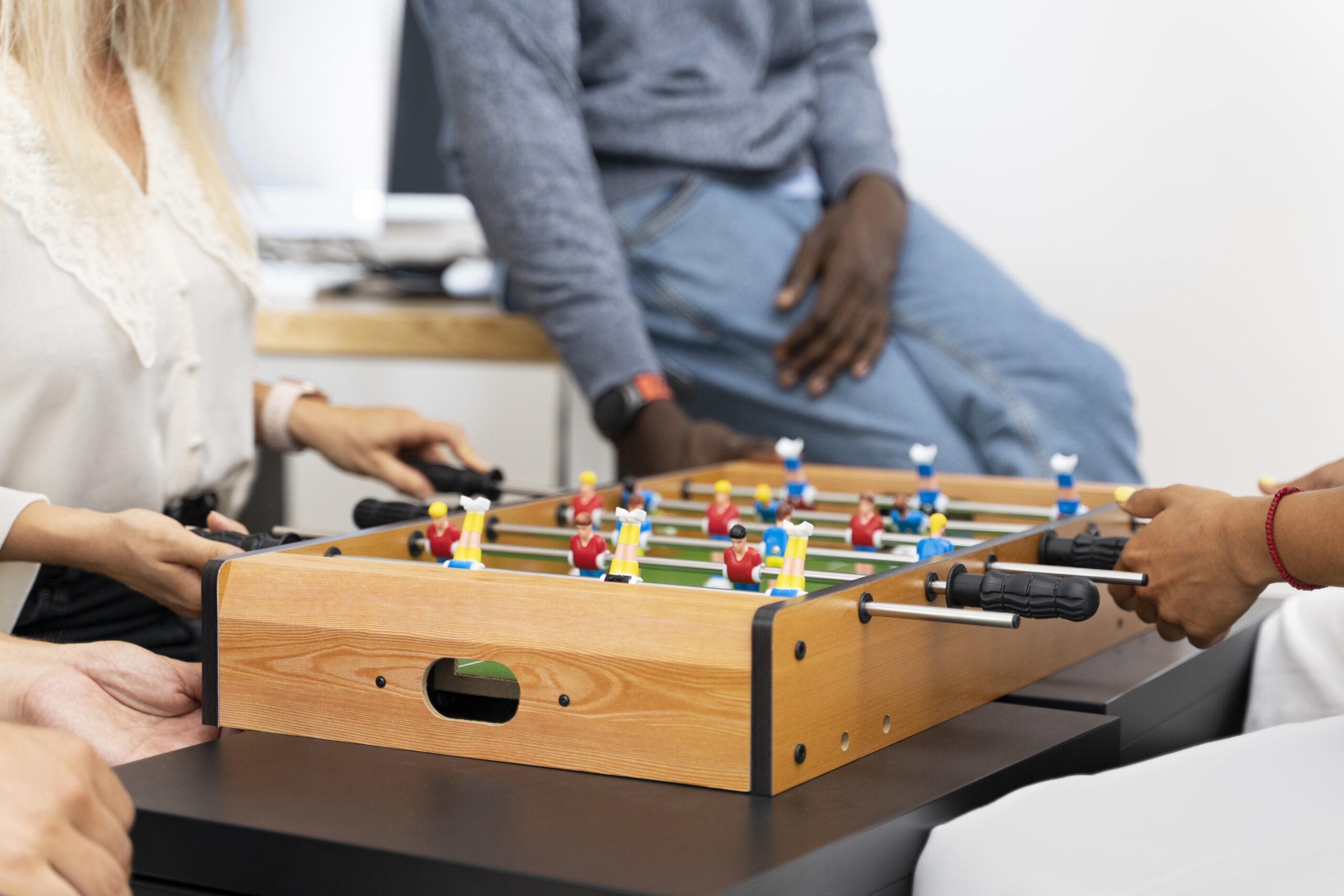 close-up-people-having-fun-while-playing-table-soccer